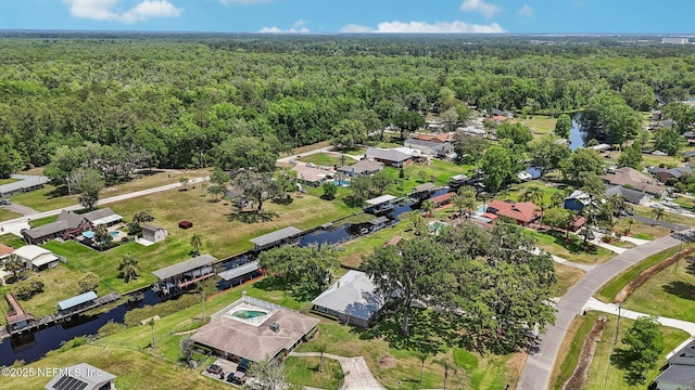 bird's eye view with a wooded view, a residential view, and a water view