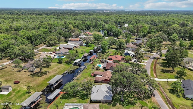 drone / aerial view with a view of trees and a residential view