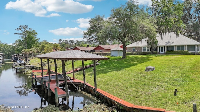 dock area featuring boat lift, a water view, and a lawn