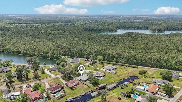 drone / aerial view with a water view and a view of trees