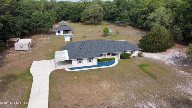 view from above of property with a heavily wooded area