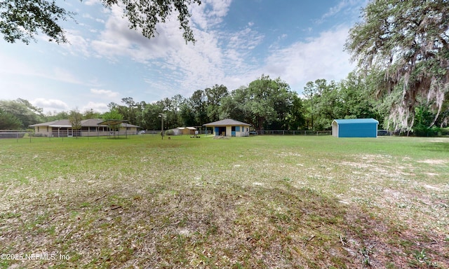 4041 Saddlehorn Trl, Middleburg, FL 32068 - view of yard featuring a shed, an outdoor structure, and view of wooded area