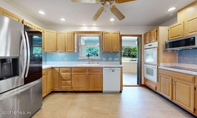 4041 Saddlehorn Trl, Middleburg, FL 32068 - kitchen with appliances with stainless steel finishes, a sink, a ceiling fan, light countertops, and recessed lighting