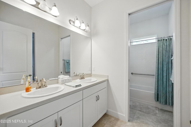 bathroom featuring double vanity, a sink, tile patterned flooring, and shower / tub combo