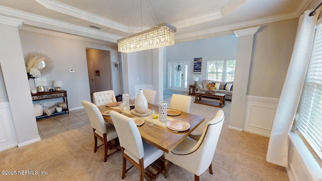 15717 Basil Creek Ct, Jacksonville, FL 32218 - dining area with light carpet, ornamental molding, a tray ceiling, and a chandelier