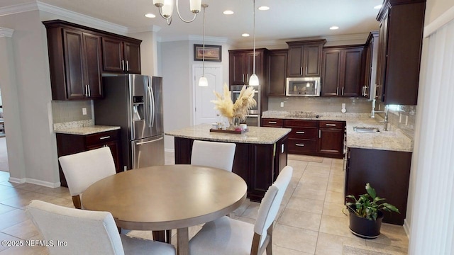 15717 Basil Creek Ct, Jacksonville, FL 32218 - kitchen featuring stainless steel appliances, a sink, a kitchen island, ornamental molding, and backsplash