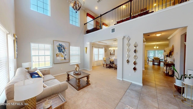 15717 Basil Creek Ct, Jacksonville, FL 32218 - carpeted living area with a chandelier, healthy amount of natural light, a towering ceiling, tile patterned flooring, and baseboards