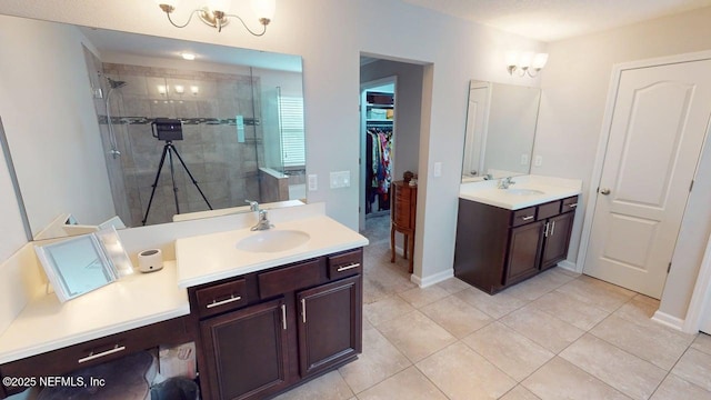 15717 Basil Creek Ct, Jacksonville, FL 32218 - full bathroom with a shower stall, two vanities, tile patterned floors, a walk in closet, and baseboards