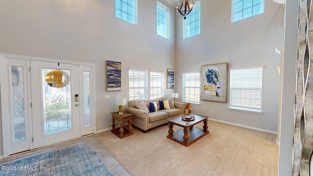 15717 Basil Creek Ct, Jacksonville, FL 32218 - tiled living area with a chandelier, a towering ceiling, plenty of natural light, and baseboards