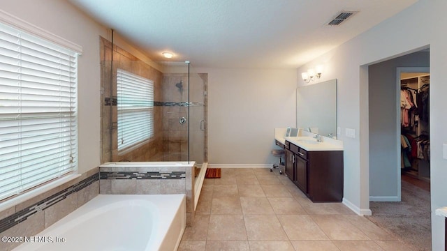 15717 Basil Creek Ct, Jacksonville, FL 32218 - bathroom with vanity, a bath, a shower stall, and healthy amount of natural light