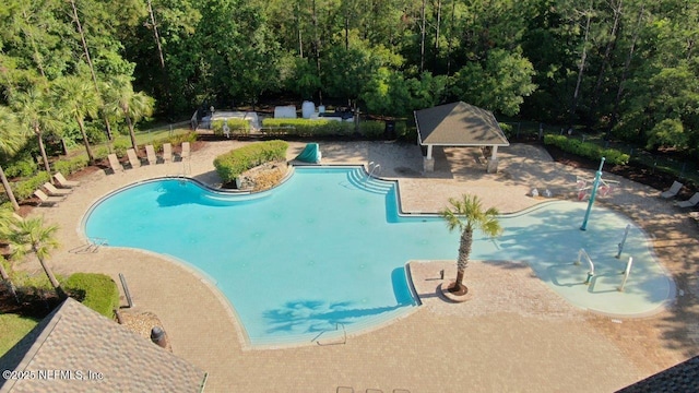 15717 Basil Creek Ct, Jacksonville, FL 32218 - community pool featuring a patio area