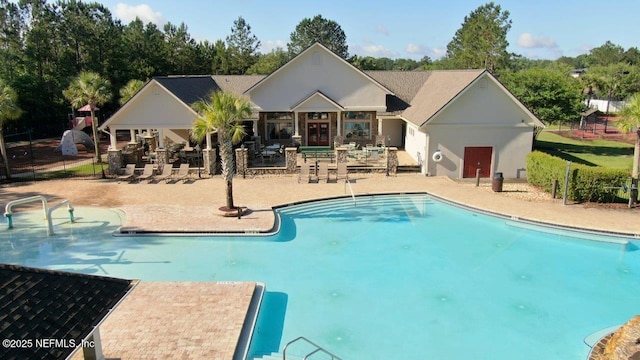 15717 Basil Creek Ct, Jacksonville, FL 32218 - community pool with a patio and view of scattered trees