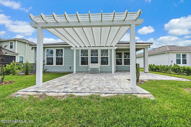 back of property with a pergola, a yard, and a patio area