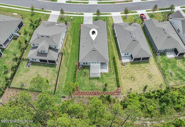 birds eye view of property with a residential view