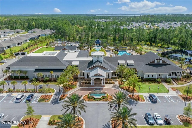 birds eye view of property featuring a wooded view