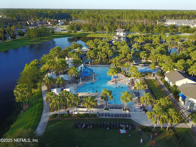 drone / aerial view with a water view and a view of trees