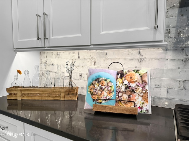 31 Tesoro Ter, Saint Augustine, FL 32095 - details with white cabinetry, backsplash, and dark countertops