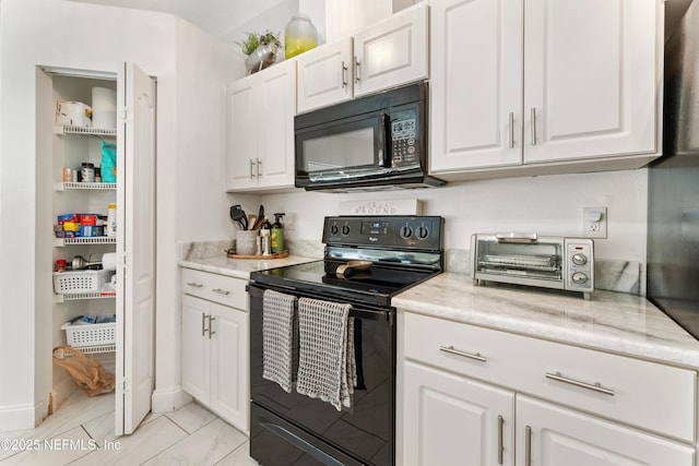 kitchen with white cabinets, black appliances, a toaster, and light stone counters