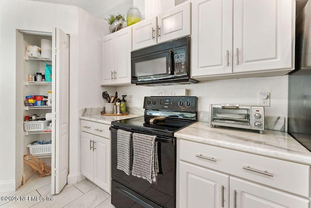 kitchen with white cabinetry, a toaster, black appliances, and light stone countertops