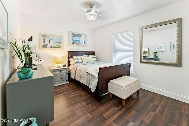 bedroom with baseboards and dark wood-style flooring
