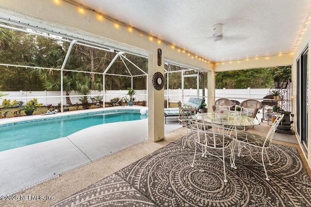 view of swimming pool featuring a patio, a fenced in pool, a fenced backyard, and a lanai