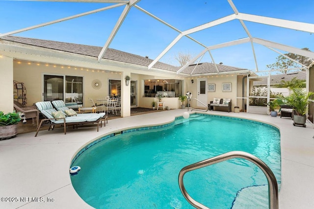 outdoor pool featuring a patio, an outdoor hangout area, and glass enclosure