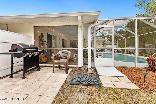view of patio / terrace featuring glass enclosure and an outdoor pool