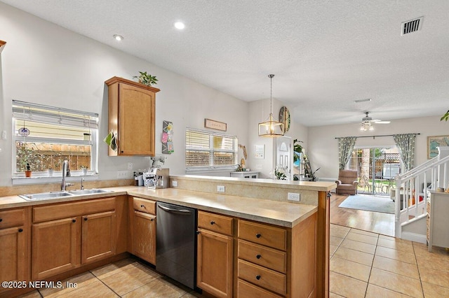 kitchen with a sink, a peninsula, dishwasher, and light tile patterned floors