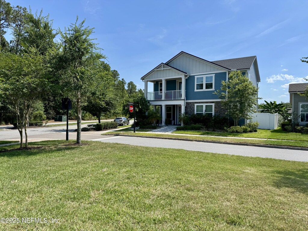 13 Verdure St, Jacksonville, FL 32259 - view of front facade featuring a balcony, board and batten siding, and stone siding