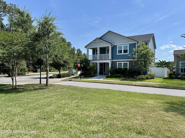 13 Verdure St, Jacksonville, FL 32259 - view of front facade featuring a balcony, board and batten siding, and stone siding