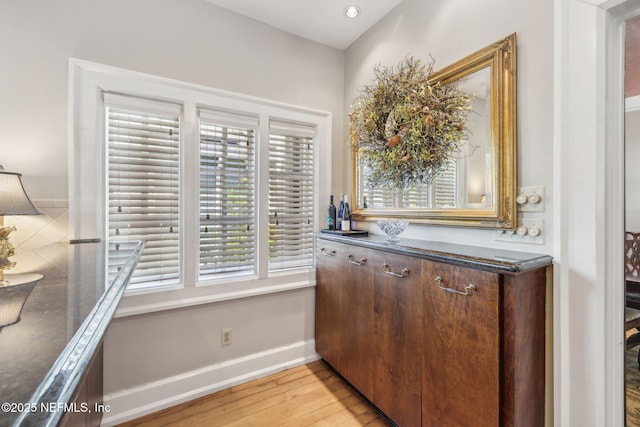 interior space with baseboards and wood finished floors