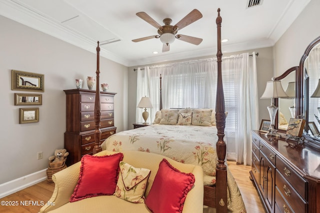 bedroom with light wood-style floors, crown molding, and visible vents