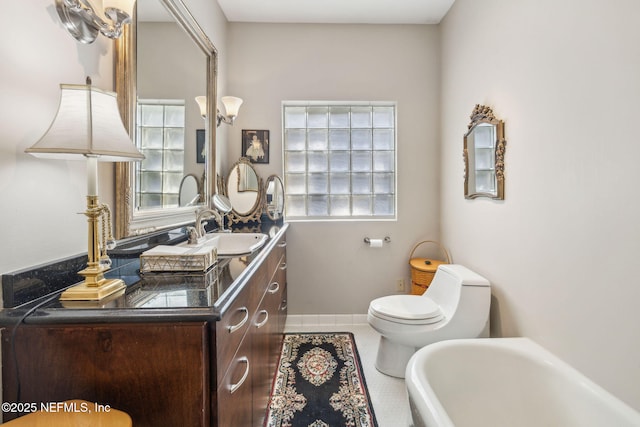 full bath with a tub, toilet, plenty of natural light, and tile patterned flooring