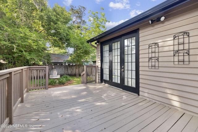 deck featuring fence and french doors