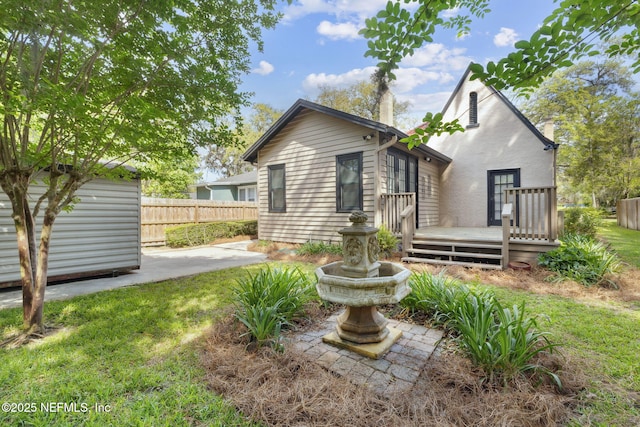 view of front of home with fence and a deck