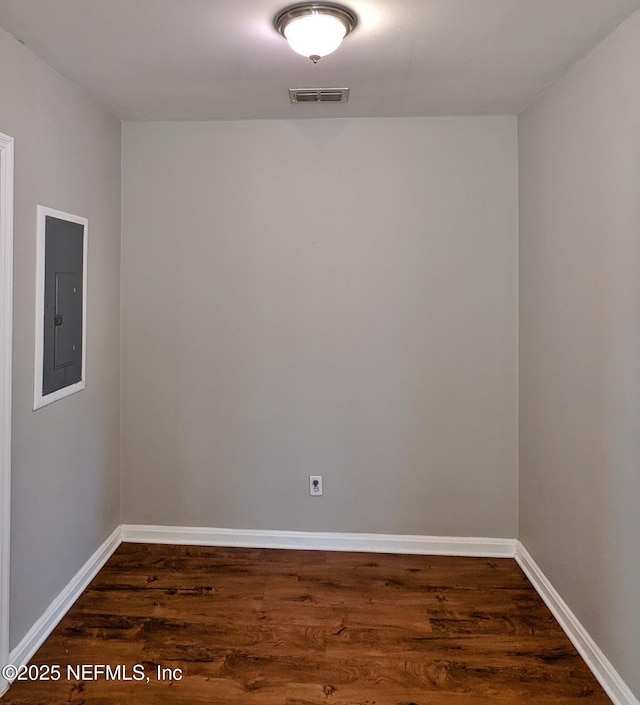 2636 Post St, Jacksonville, FL 32204 - unfurnished room with visible vents, electric panel, baseboards, and dark wood finished floors