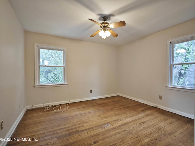 2636 Post St, Jacksonville, FL 32204 - spare room featuring wood finished floors, a ceiling fan, and baseboards