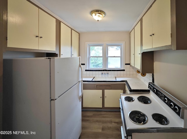 2636 Post St, Jacksonville, FL 32204 - kitchen with white appliances, decorative backsplash, light countertops, cream cabinetry, and dark wood-type flooring