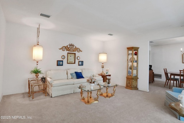 living area featuring carpet flooring and visible vents
