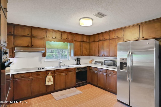 kitchen featuring appliances with stainless steel finishes, visible vents, light countertops, and a sink