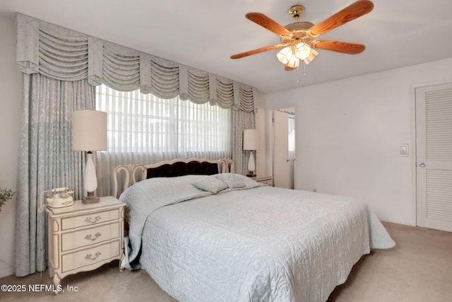 carpeted bedroom featuring ceiling fan
