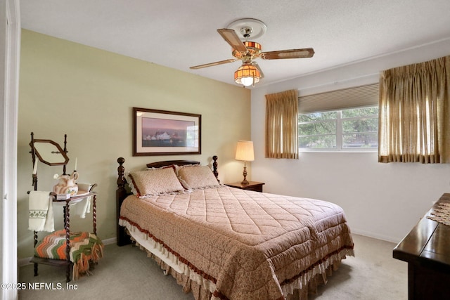 carpeted bedroom featuring baseboards and ceiling fan