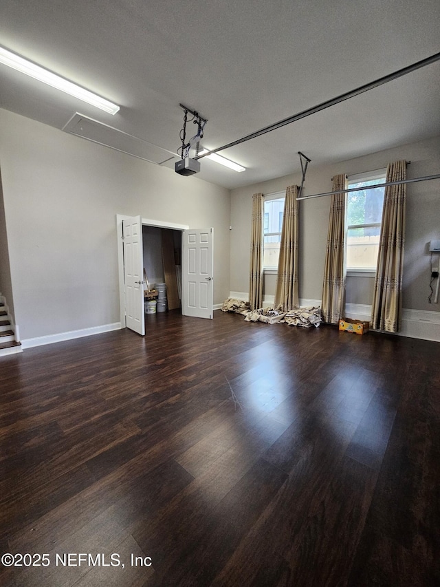 garage featuring baseboards and a garage door opener