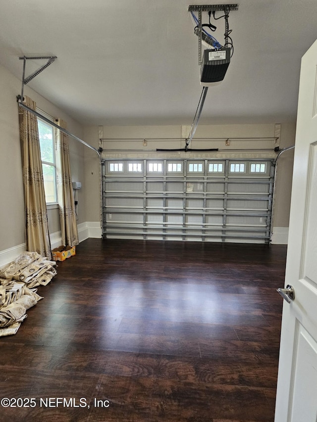 garage featuring baseboards and a garage door opener