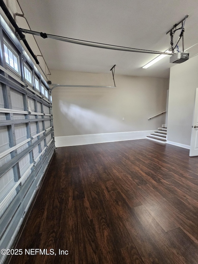 garage featuring baseboards and a garage door opener