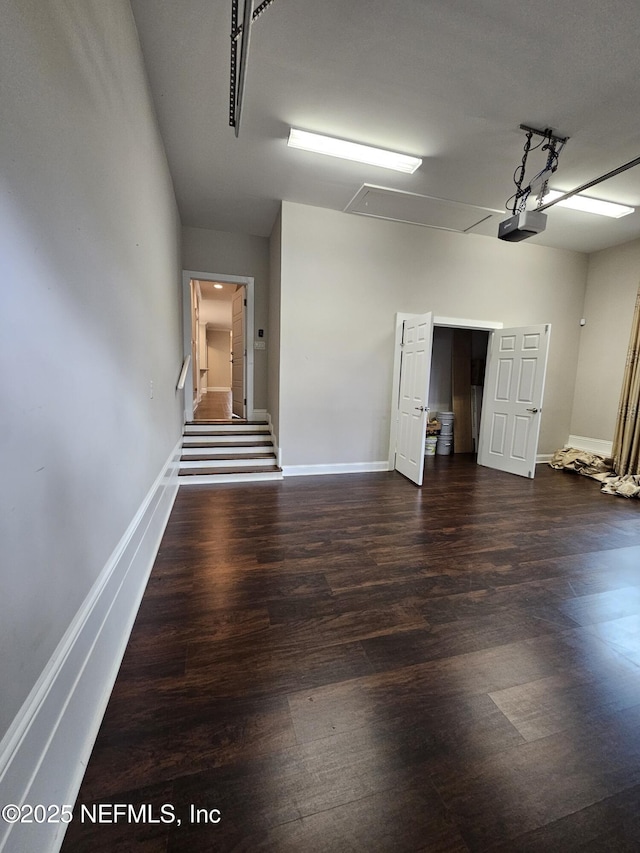 garage with baseboards and a garage door opener