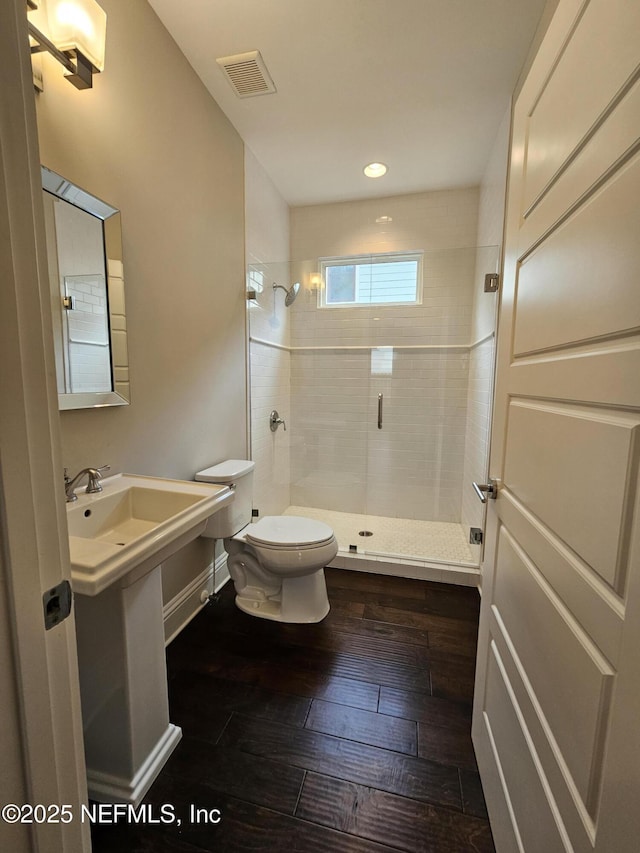 bathroom with visible vents, a stall shower, toilet, recessed lighting, and hardwood / wood-style floors