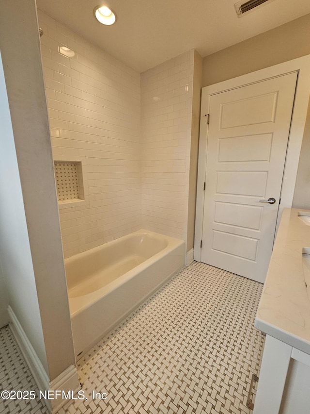 bathroom featuring shower / bath combination, tile patterned floors, baseboards, and vanity