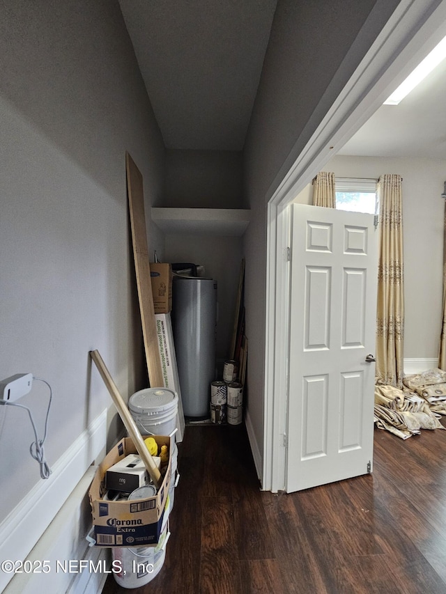 hall featuring baseboards and wood finished floors