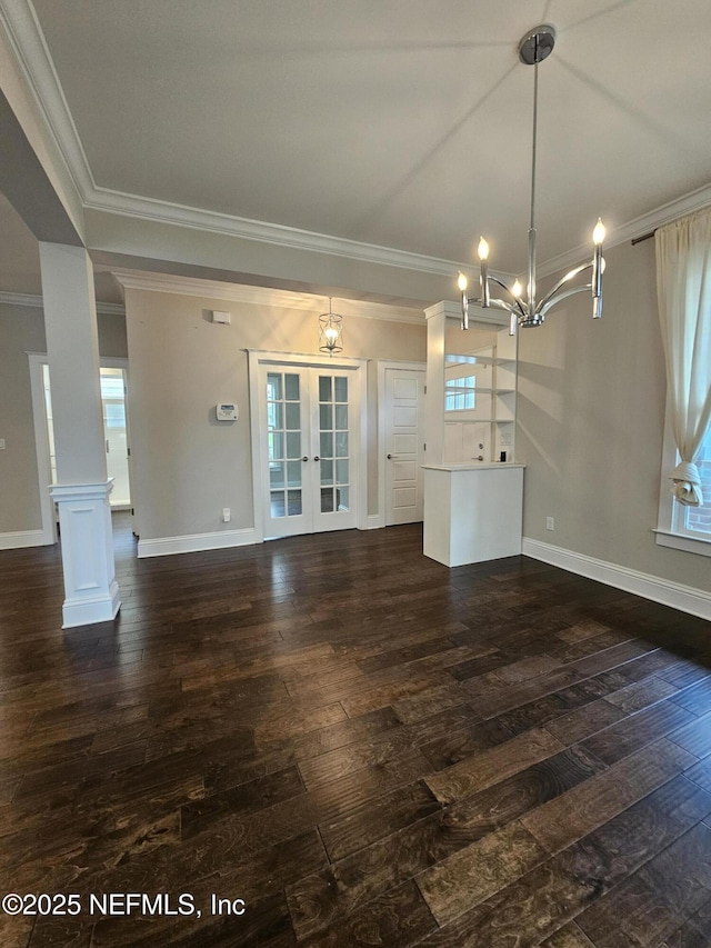 unfurnished living room with a chandelier, french doors, baseboards, dark wood-type flooring, and ornamental molding